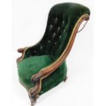 A Victorian show frame mahogany nursing chair, with a padded buttoned back, scroll carved arms and l
