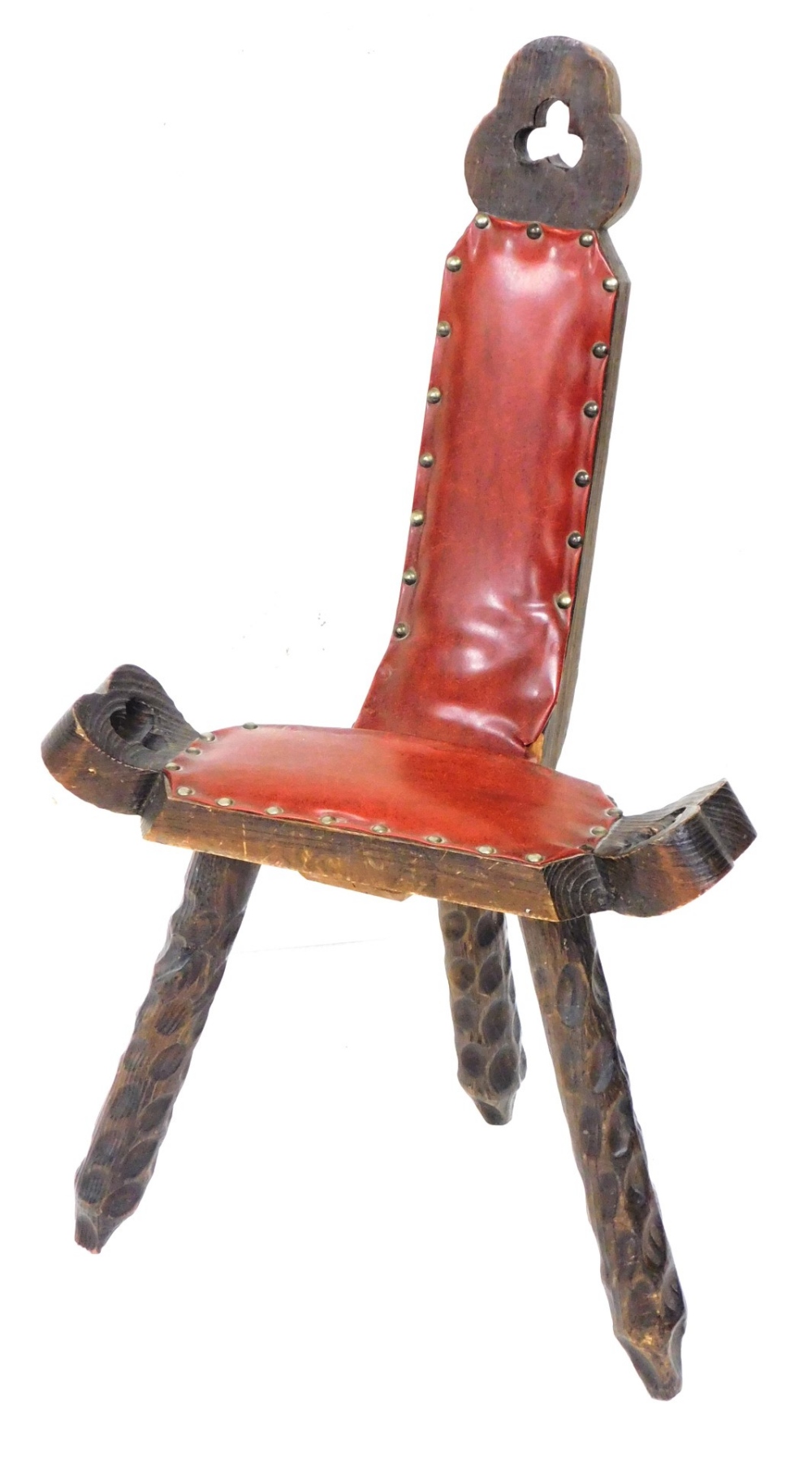 A Continental stained pine spinning chair, with red leatherette padded seat on three legs.