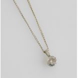 An 18ct white gold and diamond pendant, set with a brilliant cut diamond on a baguette cut diamond