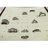 A group of paste set dress rings, various styles, contained in a wooden ring box. (10)
