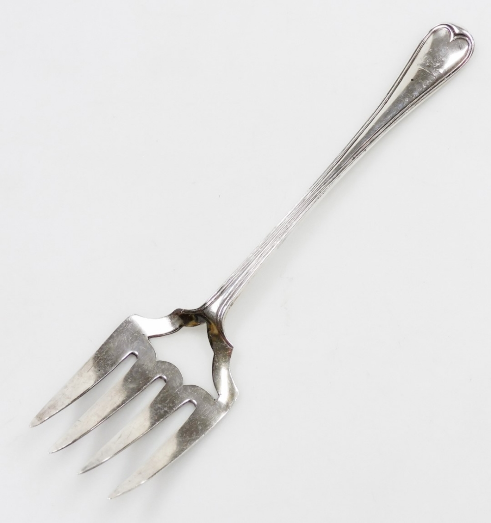 A Victorian silver Old English pattern serving fork, with four prongs and vacant shield shaped secti