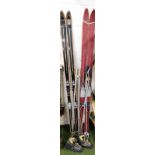 Two pairs of vintage skis and poles, for Marker Germany and Elan, 190cm long, and a pair of leather