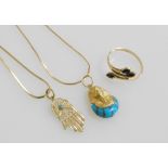 A gold and turquoise pharaoh's head pendant, on an 18ct gold neck chain, a Hamsa hand pendant, turqu