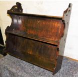 A Victorian stained oak wall shelf, with shaped end supports, 58cm high, 61cm wide.