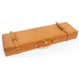 A leather gun case in light tan, with brass lock and fitted interior, 81cm.