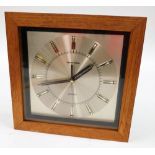 A Toshiba retro quartz wall clock, in a teak case, 32cm wide.