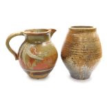 Two items of studio pottery, comprising a jug with incised decoration and banding, against a mottled