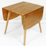 An Ercol light elm drop leaf table, on square tapering legs, 71cm high, the top 43cm x 65cm