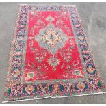 A Turkish Oushak rug, with central medallion surrounded by multiple borders, against a red ground, 2