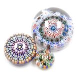 Three millefiori glass paperweights, comprising a 19thC concentric example in blue, pink and green,