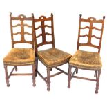 A set of three Victorian mahogany dining chairs, each with part ladder back, a brown leather seat, o