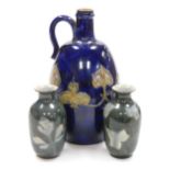 A Royal Doulton stoneware ewer, decorated with applied Art Nouveau motifs against a blue ground, imp