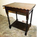 A 1920's oak two tier occasional table, rectangular top with a shaped edge, on spiral turned support