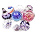 A group of Caithness glass paperweights, comprising Miniature Moonflower, Saracen, Whirlpool, Extrav