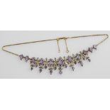 A Victorian amethyst and seed pearl necklace, set in yellow metal, on a later 9ct gold chain and cla