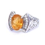 A 9ct gold and citrine ring, oval cut in a claw setting, the shank with a pierced foliate design and