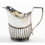 A George V silver cream jug, of semi fluted form, Sheffield 1918, 3.47oz, 9cm high.