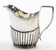 A George V silver cream jug, of semi fluted form, Sheffield 1918, 3.47oz, 9cm high.