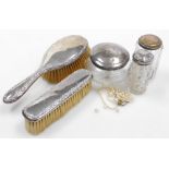 A group of dressing table items, comprising a George V silver mounted hairbrush and clothes brush, w