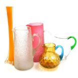 A group of glassware, to include a pair of Victorian crackle glaze lemonade jugs, in pink and clear