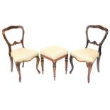 A pair of Victorian balloon back simulated rosewood dining chairs, on cabriole legs, 83cm high, and