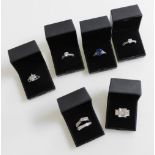 Six silver and paste set dress rings, all boxed.