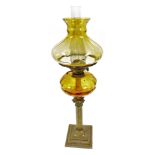 A late 19th/early 20thC Duplex oil lamp, with an amber coloured glass shade and amber glass reservoi