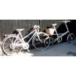 A Raleigh Lady Sprite bicycle, in white trim with a Brooks B72 seat, and a Moult Bicycles bicycle, i