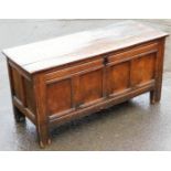 A late 17thC oak coffer, the hinged lid enclosing a vacant interior above a quadruple panel front on