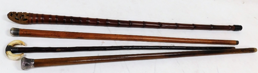 A group of walking canes, comprising a Victorian malacca cane with silver mount, London 1900, 90.5cm