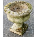 A composition planter, of urn form, on a square base, 44cm high.