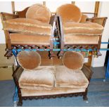 An early 20thC mahogany bergere suite, comprising two seater sofa, with cane filled arms and upholst