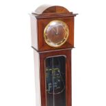 A 1920/30's electric grandmother clock, the dial with gilt Arabic numerals, above a glazed door expo