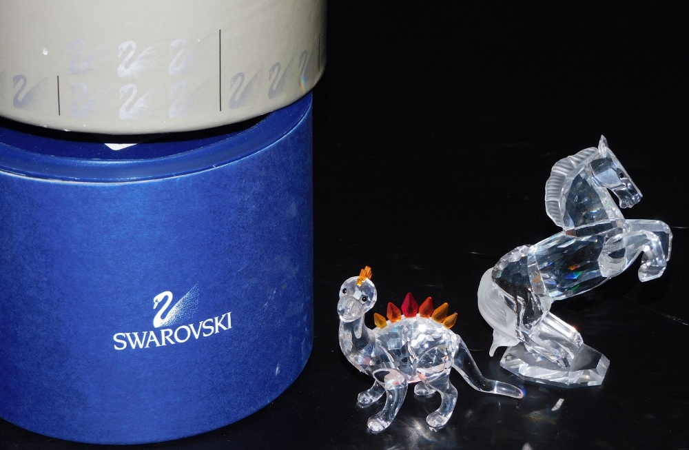 Two items of Swarovski crystal, comprising a rearing horse, A7612, 11cm high, and a dinosaur, A7550,