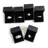 Six silver and paste set dress rings, all boxed.