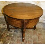 An early 20thC oak demi lune shaped work table, the hinged lid enclosing a fitted interior on turned
