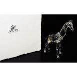 A Swarovski crystal figure of a giraffe, A7603, 14cm high, in fitted box and outer packaging.