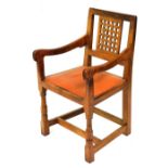 A Robert Thompson Mouseman oak carver chair, with lattice work panel back, a studded leather seat, o