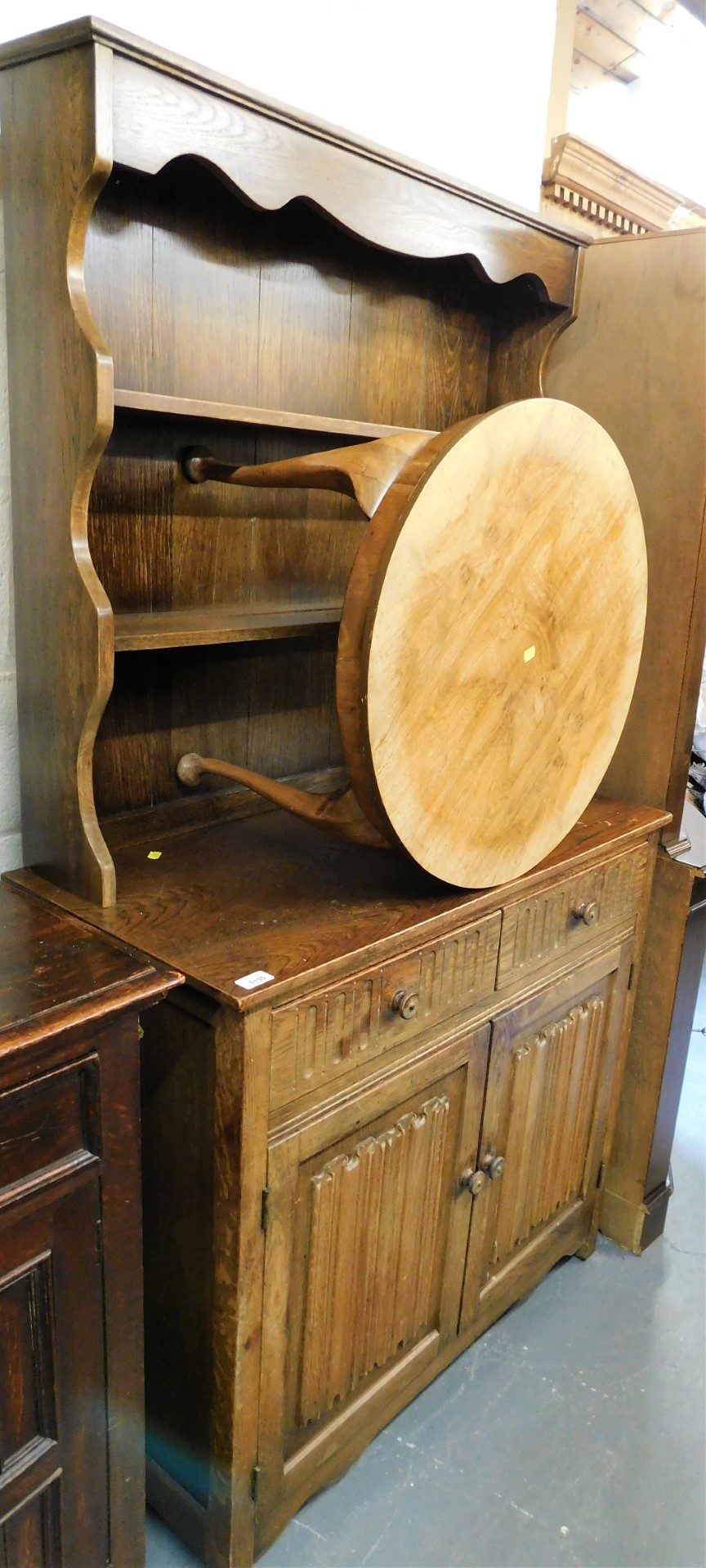 An oak dresser, the top with two shelves above two drawers and two cabinets, 175cm high, 95cm wide,