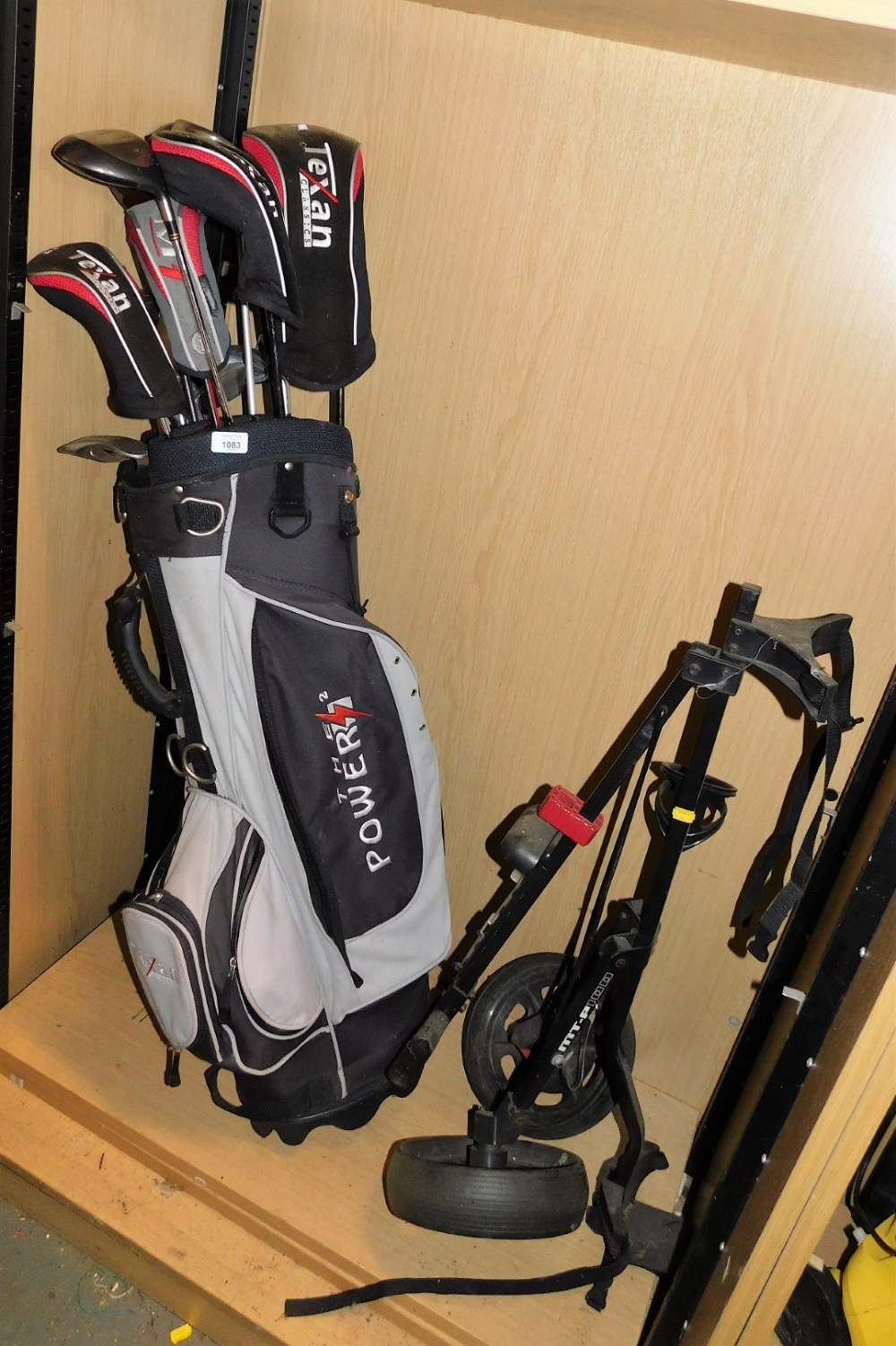 A Power 2 golf bag, containing various golf clubs, and a MT-P100 golf caddy.