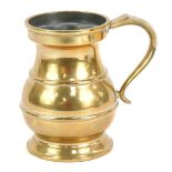 A brass quart tankard, with shaped handle and moulded bands, marked V R 29, 17cm high.
