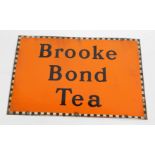 A Brooke Bond Tea enamel advertising sign, on orange ground with chequered border, 51cm x 76cm.