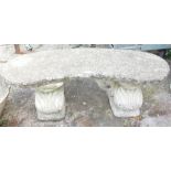 A reconstituted stone garden bench, the arch top of two squirrel supports, 42cm high, 118cm wide, 40