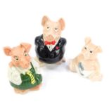 Three Wade Natwest piggy banks, comprising father, daughter and baby, the largest 20cm high.