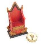 A cast novelty Elizabeth II Coronation throne money box, the red and gold ground marked ER 1953, 22c
