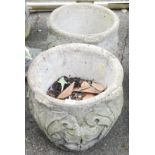 A pair of reconstituted stone planters, each with applied moulding, 45cm high, 42cm diameter.