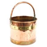 A copper and brass coal bucket, with swing handle and buckle supports, 23cm high, 29cm diameter.