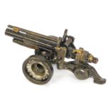 A novelty bolt cannon, formed of old cogs and bolts, 20cm wide.