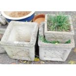 A pair of reconstituted stone planters, each square set, with patched star design, 36cm high, the to