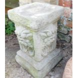 A reconstituted stone stand, with square top and lion mask sides, 42cm high, the top 26cm x 26cm.